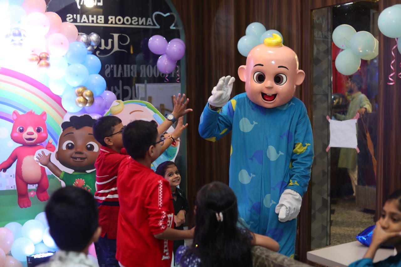 Child enjoying the CoComelon JJ mascot at a Toywala event