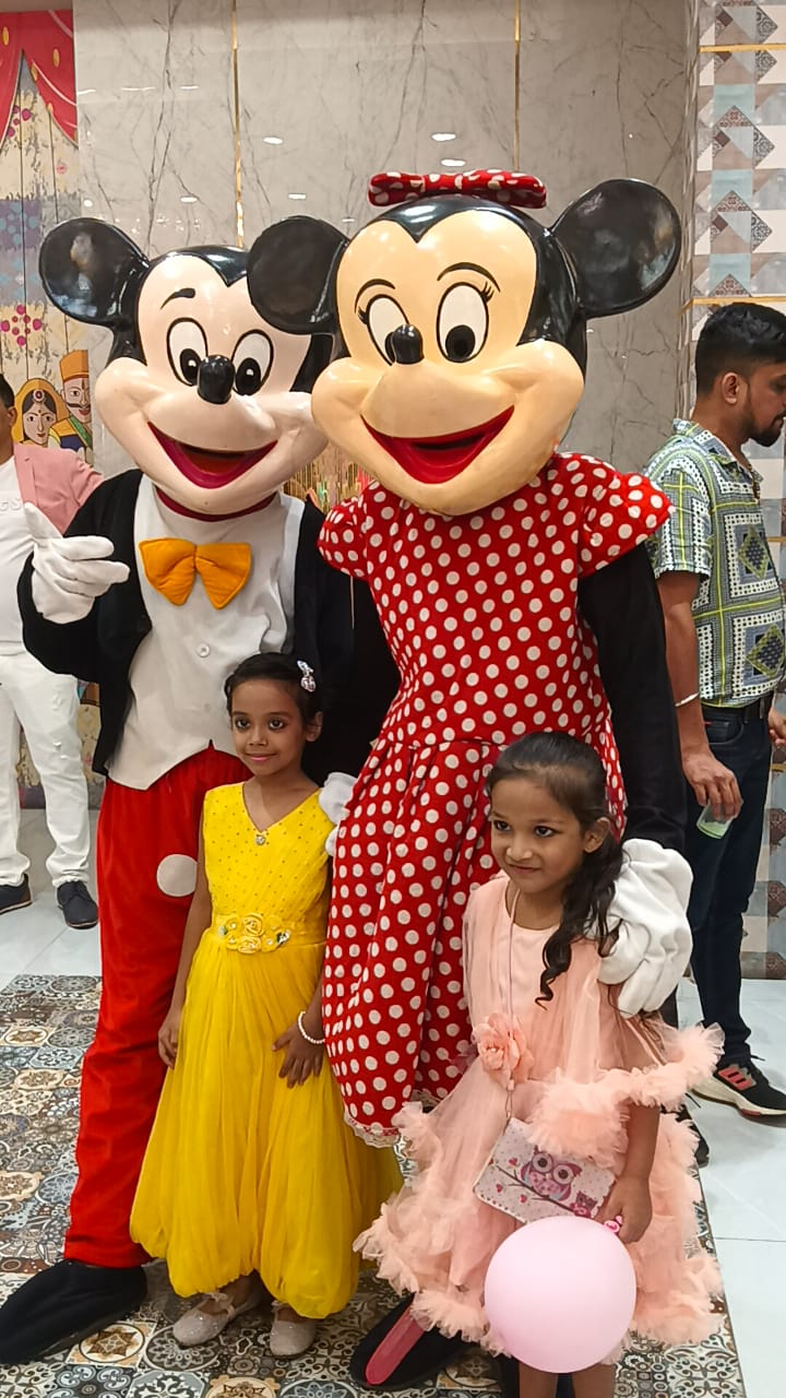 Child enjoying the Mickey & Minnie mascot at a Toywala event