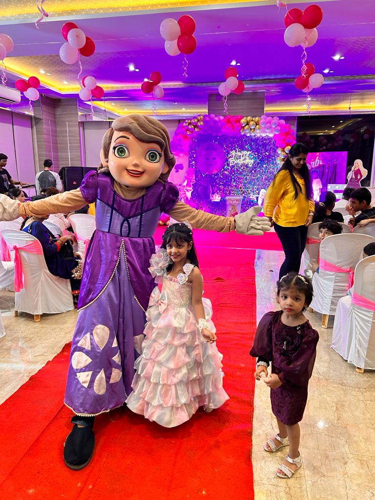 Child enjoying the Princess Sofia mascot at a Toywala event